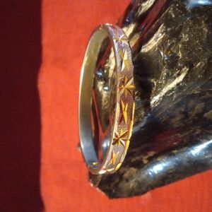 Gold tone diamond cut bracelet.